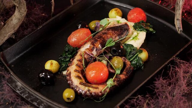 Octopus dishes with beautiful decor. Slow motion picture of food.
