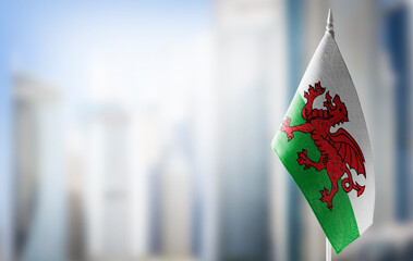 A small flag of Wales on the background of a blurred background