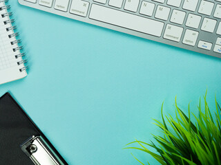 Top view above of magenta workplace with keyboard, paper. Copy space for your text, Flat lay. Office work and office conception.