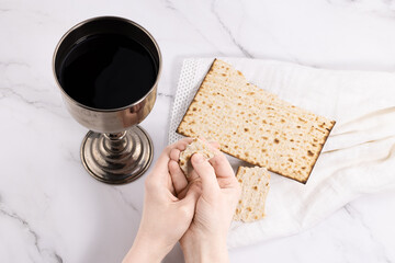 holy communion chalice with wine and bread. Lord's supper and hands folded in prayer