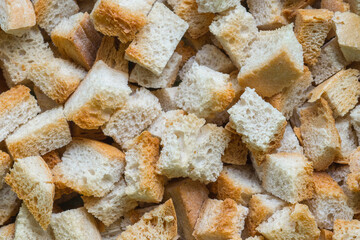 Top view on crispy bread cubes. Pile of croutons from white bread