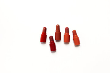 Lipstick. Fashion Colorful Lipsticks over white background. Lipstick tints palette, Professional Makeup and Beauty. Beautiful Make-up concept. Lipgloss. Lipsticks closeup