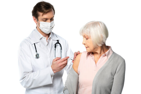 Doctor In Medical Mask Doing Vaccination Of Senior Patent Isolated On White