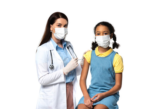 Doctor Holding Syringe With Vaccine Near African American Kid In Medical Mask Isolated On White