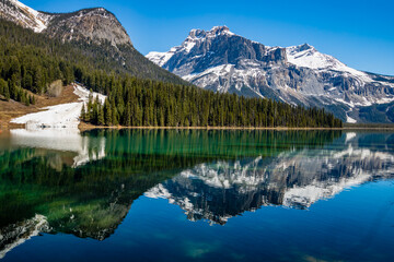 Last vestages of winter hang onto Emerald Lake. Yoho National Park. British Columbia, Canada.