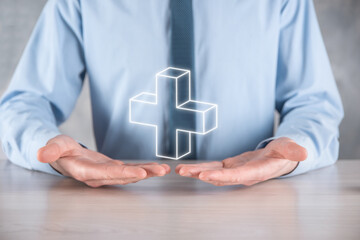 Businessman hold 3D plus icon, man hold in hand offer positive thing such as profit, benefits, development, CSR represented by plus sign.The hand shows the plus sign