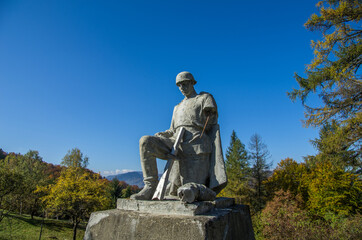 Fototapeta na wymiar Pass Nemchich. Carpathians. Ukraine. October 11, 2013; A destroyed monument to a Soviet soldier among the Carpathian mountains.