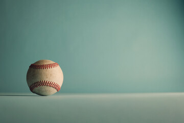 Vintage baseball background with used game ball on retro color background with copy space.