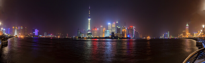 Obraz premium Panoramic view of the skyline of Shanghai's Pudong district from the famous promenade the Bund in the evening