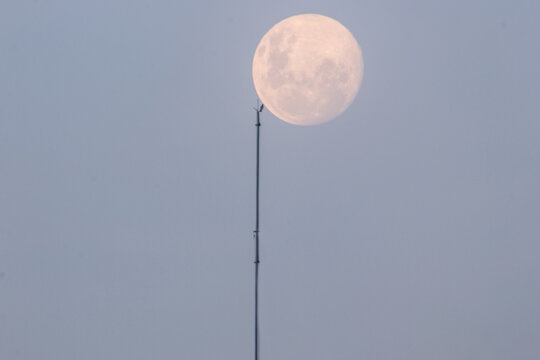 full moon rising seen at ipanema beach in rio de janeiro.