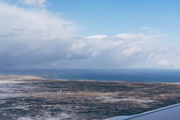 Fototapeta na wymiar Icelandic landscape outside the plane window. Travel background.