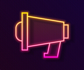 Glowing neon line Megaphone icon isolated on black background. Speaker sign. Vector