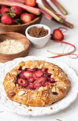 Baked galette with strawberry and rhubarb, pie on the table