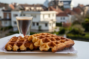 Belgian sugar waffles with black coffee served outdoor