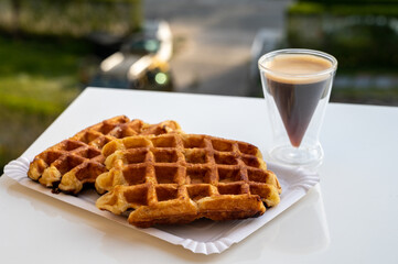 Belgian sugar waffles with black coffee served outdoor