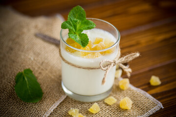 Sweet homemade yogurt with candied fruits in a glass