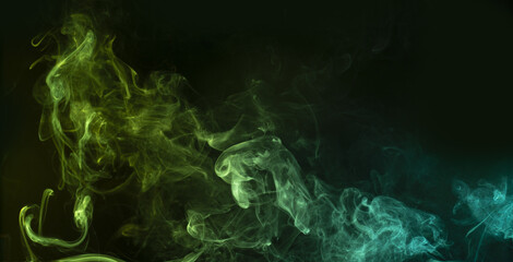 Fototapeta premium Bluish-green swirl of smoke on black background. Abstract ethereal backdrop