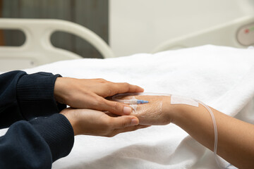Elder senior hold  woman patient hand sleeping on bed in hospital room. Health care medical concept
