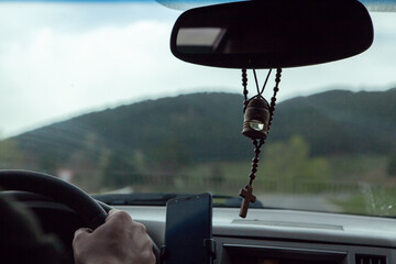 the cross is hanging in the car