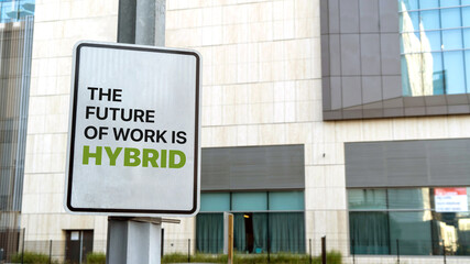 The Future of Work is Hybrid sign in a downtown city setting	
