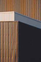 Evening sunlight and shadow on surface of gray and white corrugated metal factory building in perspective side view and vertical frame