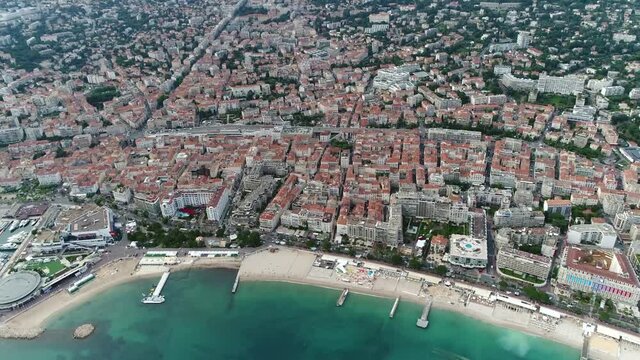 Aerial helicopter view of Cannes a city located on the French Riviera it is a commune in the Alpes Maritimes department and host town of the annual Film Festival 4k high resolution quality footage