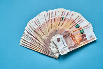 five thousand Russian ruble bills on a blue background