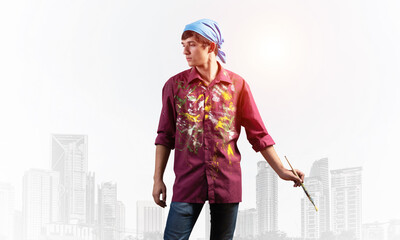 Young artist posing with paintbrush