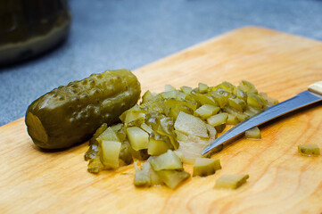 Cooking at home. Cut the pickled cucumber for the salad.