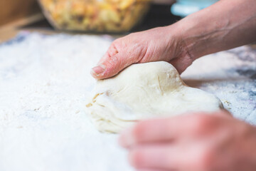 Kneading traditional dough in the kitchen, close up