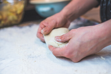 Kneading traditional dough in the kitchen, close up