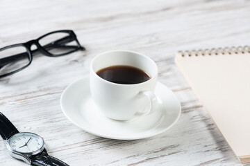 Top view office desk with white cup of coffee