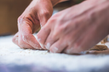 Rolling traditional dough in the kitchen, close up