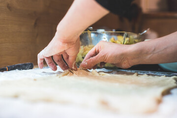 Rolling traditional dough in the kitchen, close up