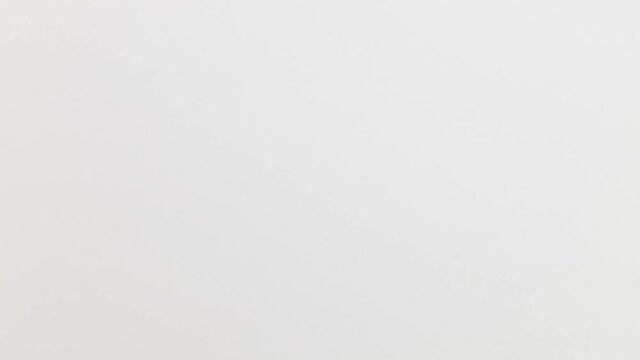 Stop Motion Animation_White paper ball unwrapping on green background