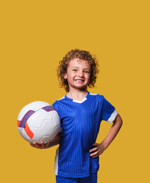 Latino Boy Soccer Player Holds Ball On Isolated Background