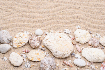Sea sand with stones and seashells. Summer concept