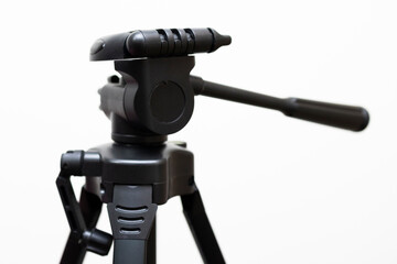 Black tripod on white background.