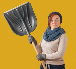 a woman in a hat and a scarf swung a large snow shovel, on a yellow background