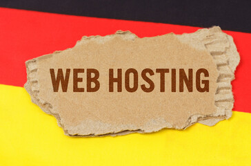 Against the background of the German flag lies cardboard with the inscription - Web Hosting