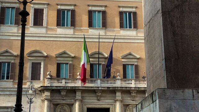 the flags of Italy and the European Union on the main balcony of Palazzo Montecitorio in Rome