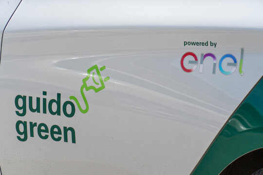 Cefal&ugrave;, Italy - May 8, 2019: Guido green banner over an electric vehicle powered by Enel Energia