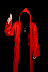 Person in red cloak pointing up with fingers. Scary figure in mantle isolated on black background. ...