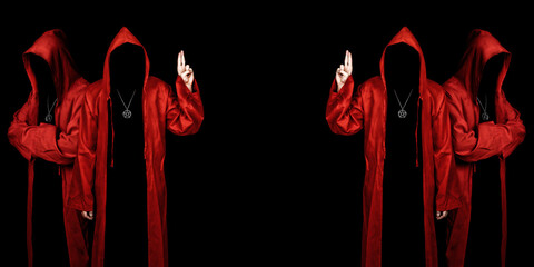 People dressed in a red robes looking like a cult members on a dark background. Pointing up with fingers. Ghostly figure. Sectarian. Copy space.  - obrazy, fototapety, plakaty