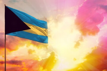 Fluttering Bahamas flag in top left corner mockup with the space for your text on beautiful colorful sunset or sunrise background.