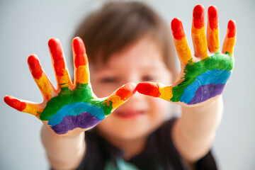 little girl showing her palms with rainbow