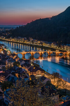 Heidelberg panorama with old city, old bridge and Neckar river after sunset. Beautiful illuminated. Vertical.