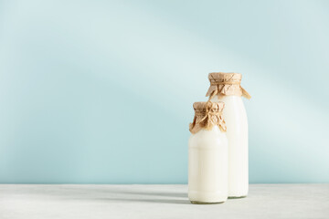on dairy plant based milk in bottles and ingredients on blue background. Alternative lactose free milk substitute