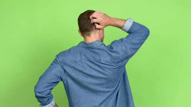 Brazilian handsome man on back position looking back while scratching head over isolated background