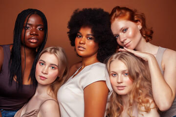 Fototapeta premium young pretty caucasian, afro, scandinavian woman posing cheerful together on brown background, lifestyle diverse nationality people concept